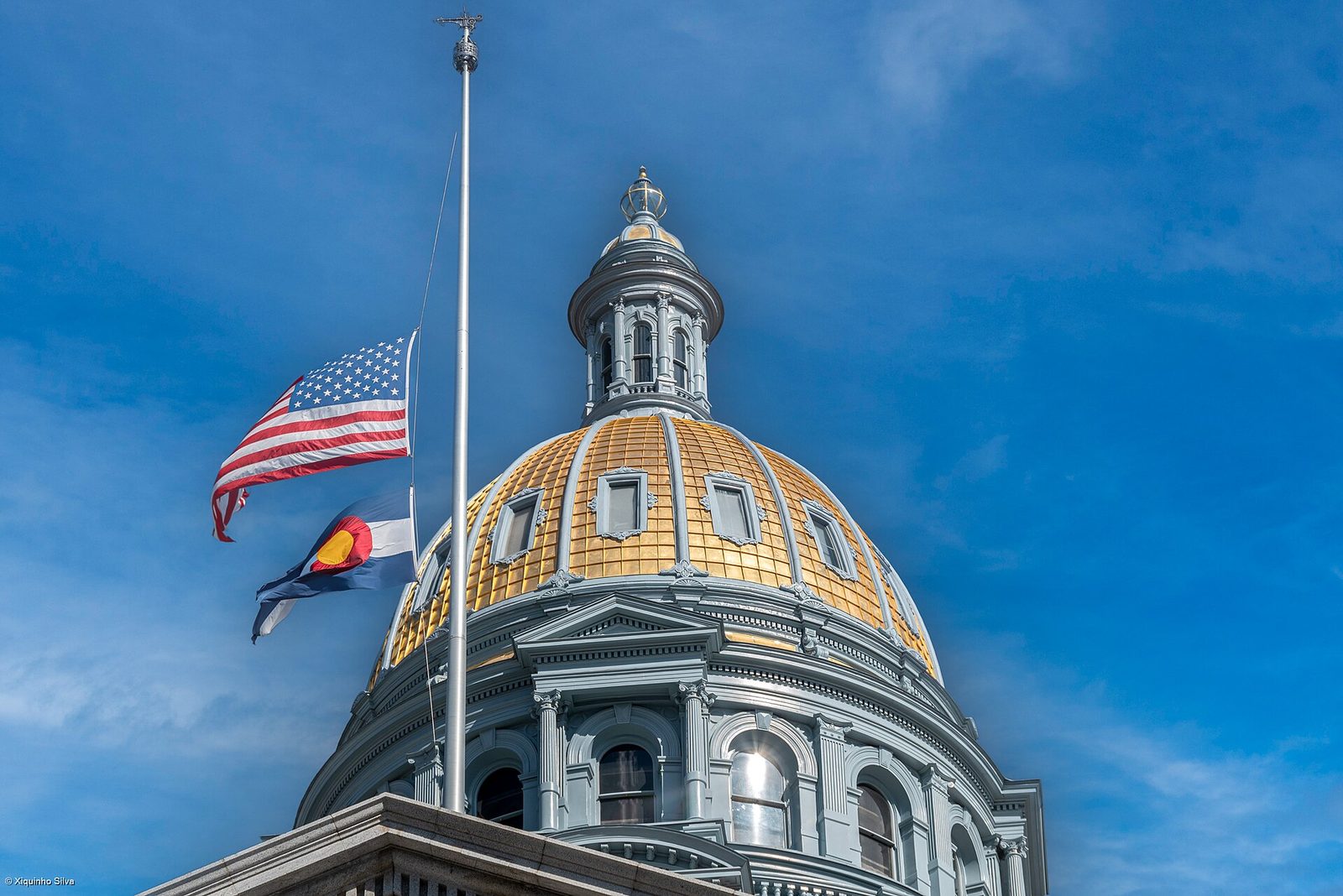 The gold dome of the Colorado State Capitol on Colfax Avenue in Denver